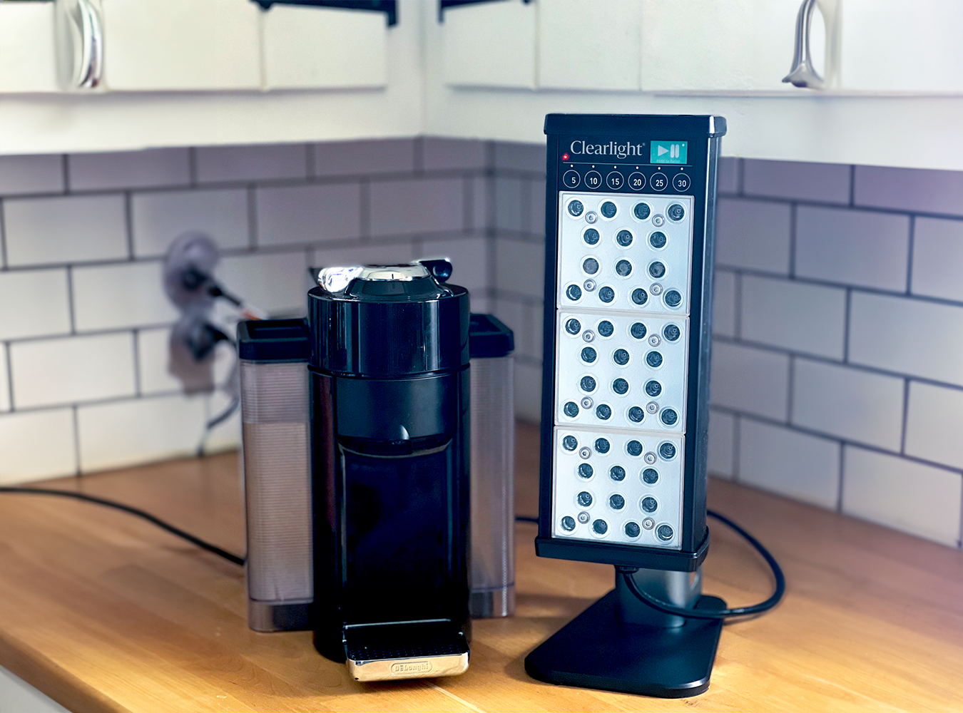Black PERSONAL Tower sitting on a kitchen counter next to a coffee maker.
